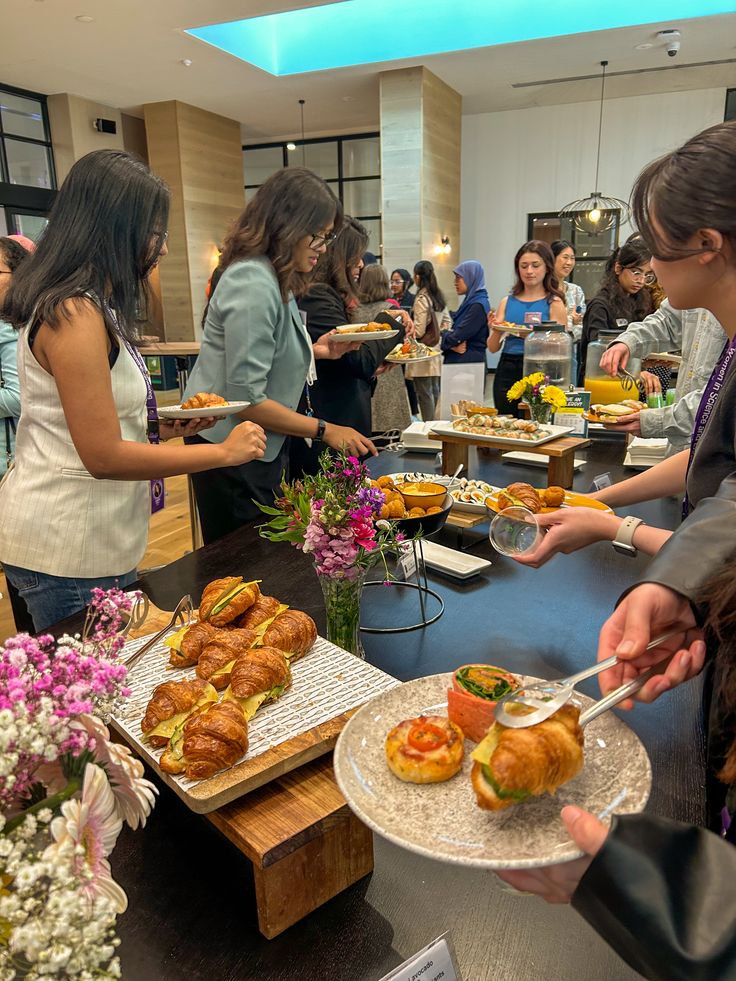 People enjoying a catered breakfast spread at a corporate event.